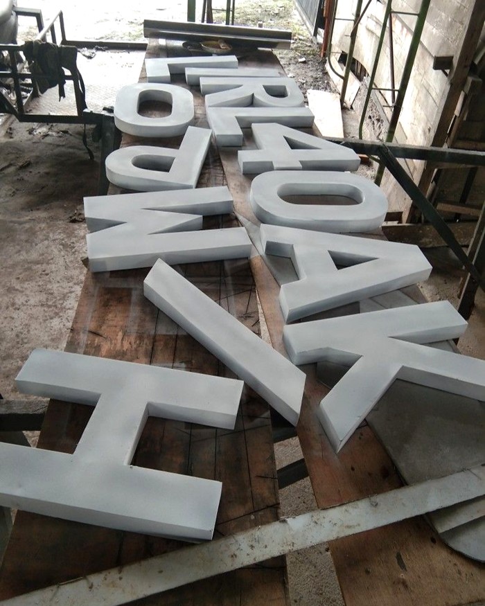 Dimensional letters arranged on a workshop table